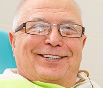 Smiling older man in dental chair