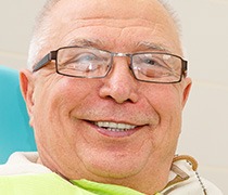 Smiling older man in dental chair