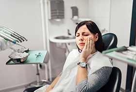 Woman with tooth pain visiting emergency dentist in Wethersfield, CT