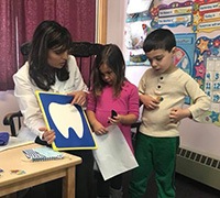 Dentist showing children tooth chart