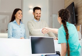 Man talking to receptionist