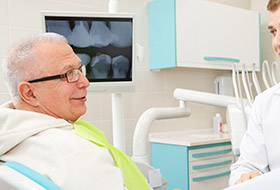 Smiling older man in dental exam chair