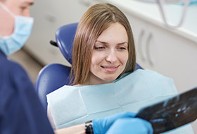 Dentist and patient looking at x-rays