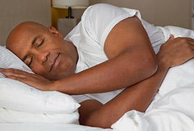 Man sleeping soundly in bed