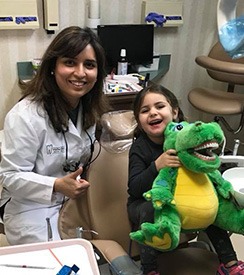 Dentist and young patient in dental exam room