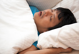 Man sleeping soundly in bed