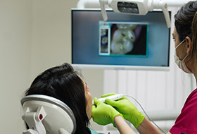 Dentist and team member looking at digital images