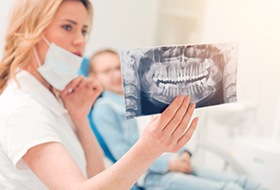 Dentist and patient looking at X-rays