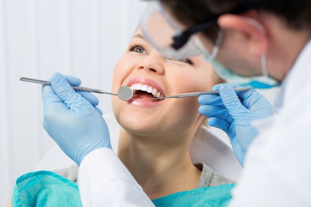 dentist treating smiling patient