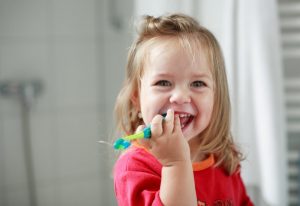 little girl with a toothbrush