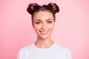 woman smiling after seeing cosmetic dentist 