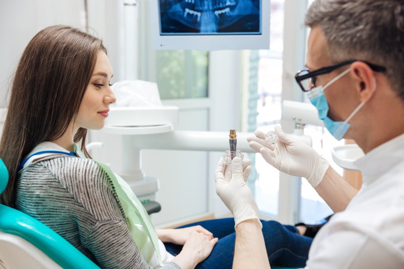 Implant dentist explaining dental implants to patient