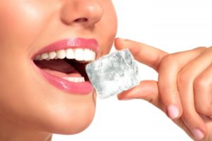 close up of person about to chew on an ice cube 