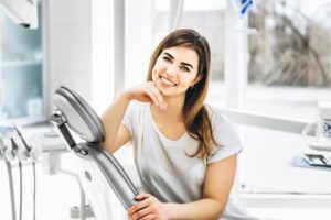 Woman sitting in a dental chair smiling