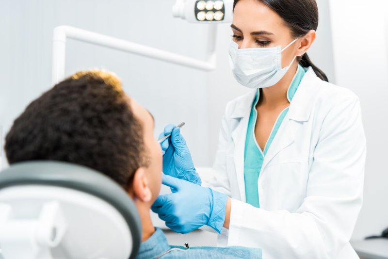 Emergency dentist conducting a dental exam