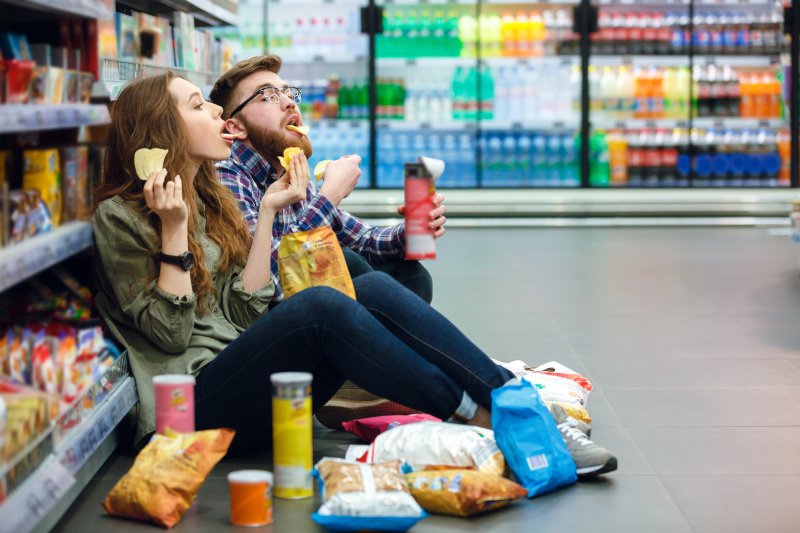 Couple enjoying snacks at the grocery store