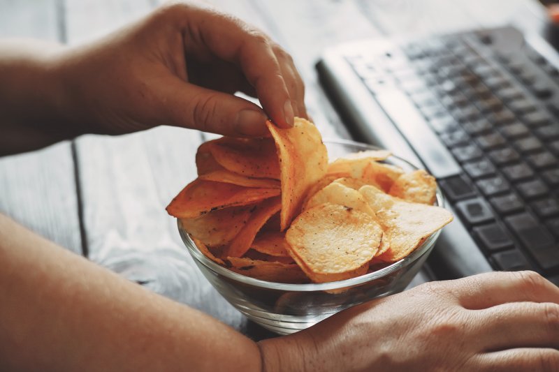 Person snacking on chips