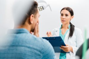 man talking to dentist 