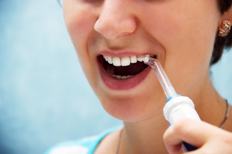 closeup of woman using Waterpik