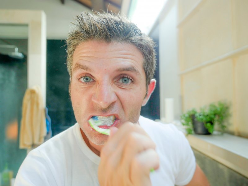 A man brushing his teeth too hard in Wethersfield