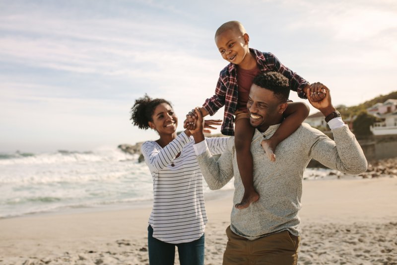 family playing on the beach