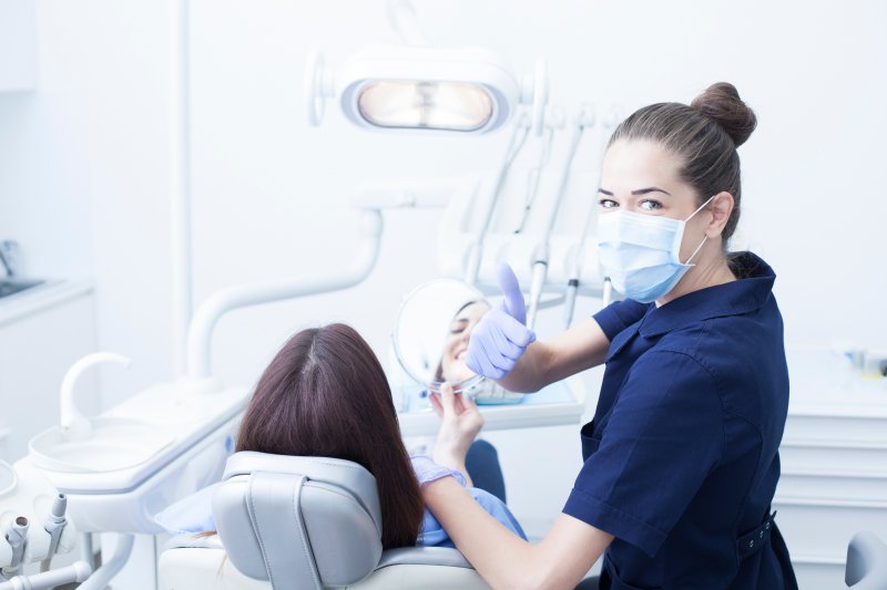 A dental hygienist smiling at a patient