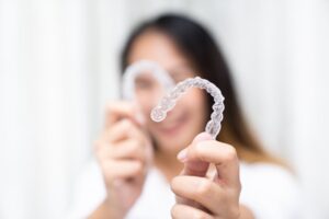 Woman using clear aligners to fix her bite problems