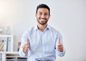 Man smiling while recovering from his wisdom teeth extraction